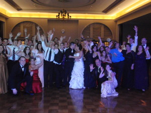 Wedding-bride-and-groom-kissing-friends-waving